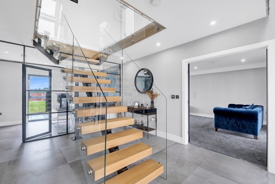 Timber staircase with glass balustrade at Aldridge Farm